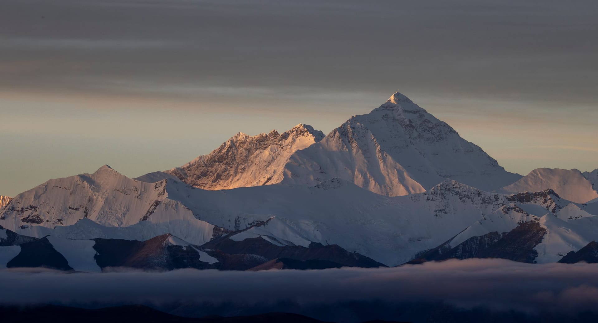 Mount Everest and the Himalaya range glowing at sunrise