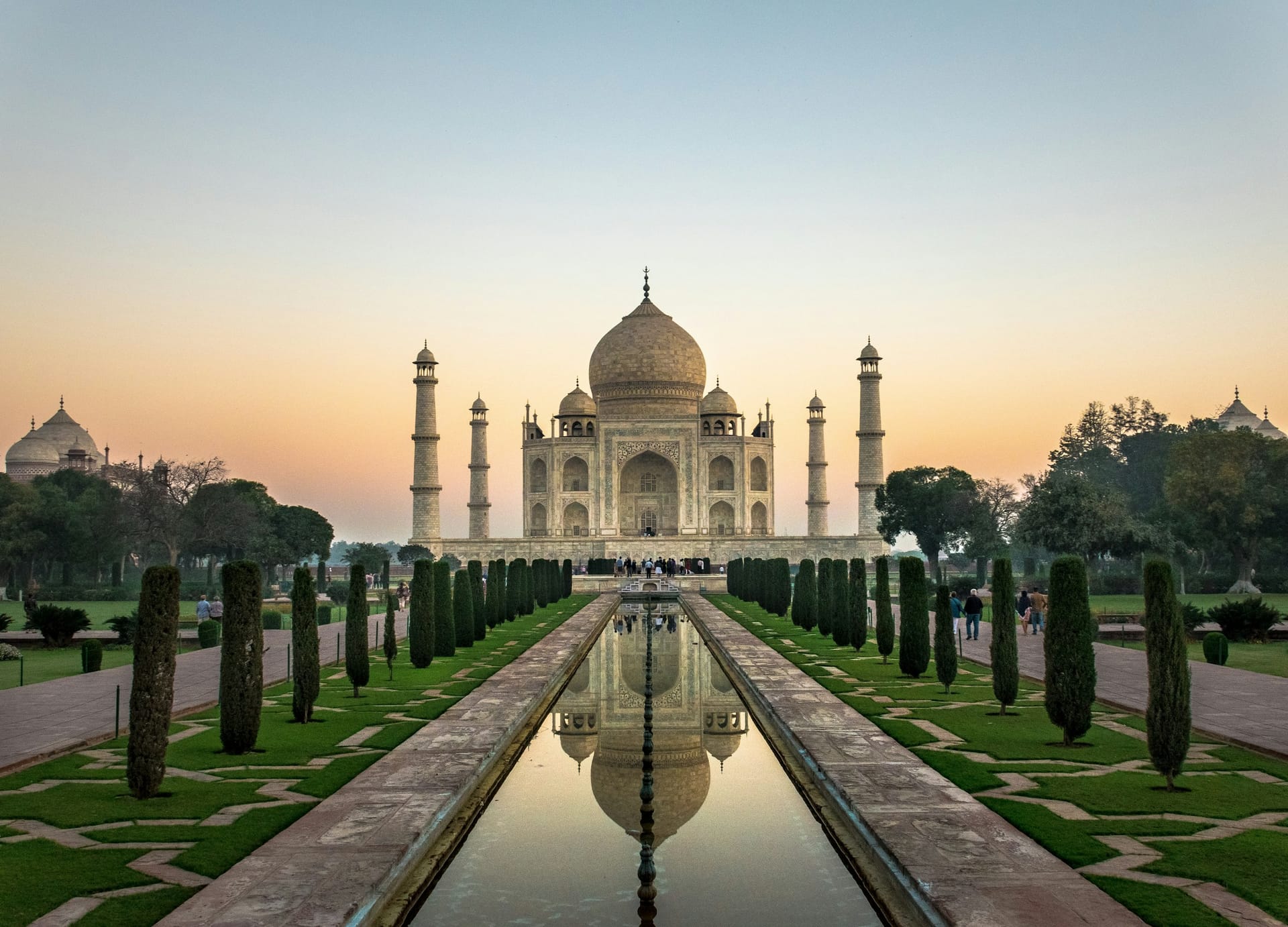 The Taj Mahal catching the first light above its reflecting pool in Agra