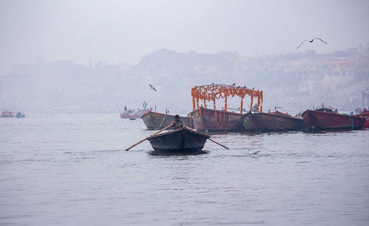 A lone rowboat in the Ganges fog at Varanasi