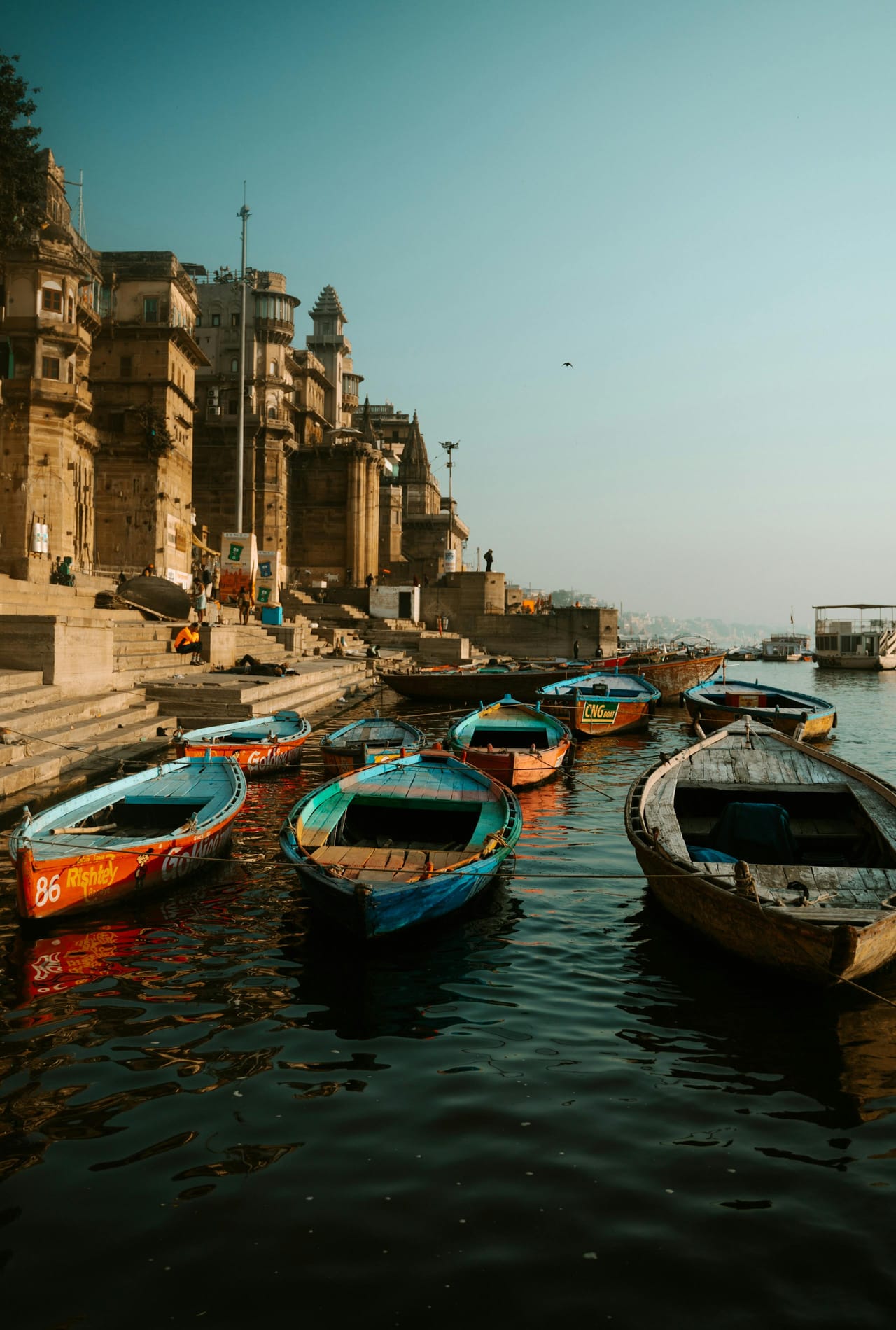 Wooden boats and a temple on the Ganges riverfront in Varanasi