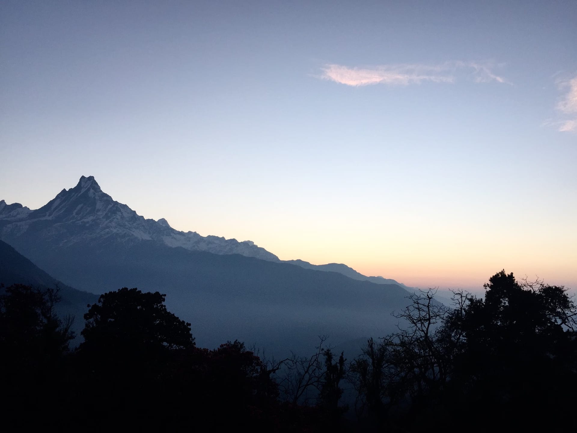 First light on the high Himalaya above Ghandruk, mist still holding the valley floor