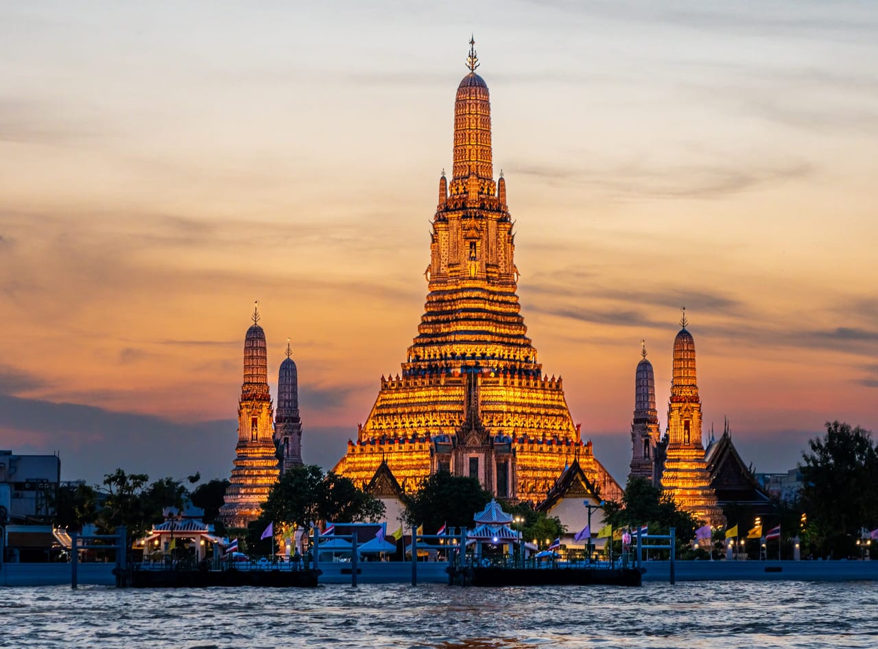 Wat Arun temple on the Chao Phraya river at sunset, Bangkok