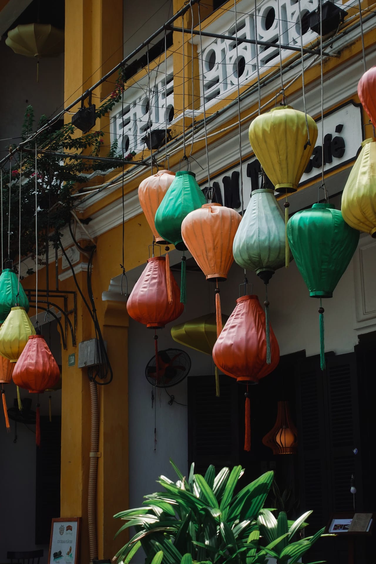 Silk lanterns hung along an old shophouse wall in Hoi An